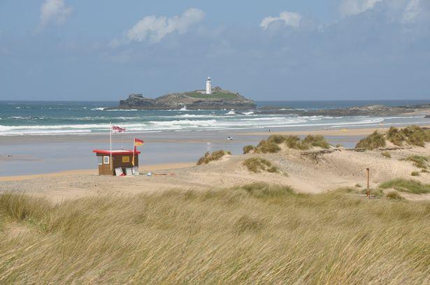 View of Godrevy Islandand lighthouse and the beach and sand dunes of Gwithian Towans